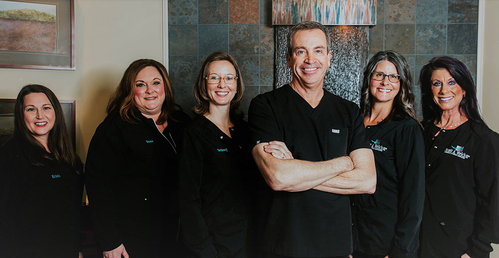 Photo of Dr. Scott Welch and his dental team of hygeinists