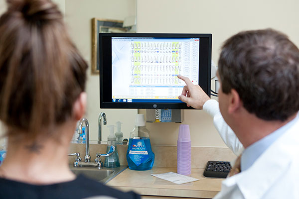 Photo of dentist explaining removing a tooth